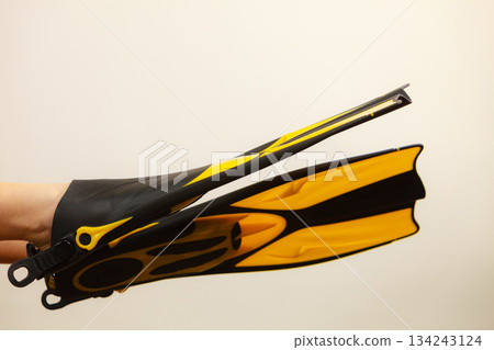 Woman presenting flippers female legs in fins 134243124