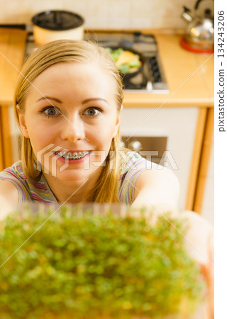 Happy woman holding cuckooflower cress 134243206