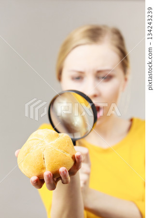 Shocked woman magnifying bun bread roll Shocked woman magnifying bun bread roll 134243239