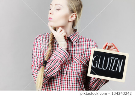 Woman holding board with gluten sign 134243242
