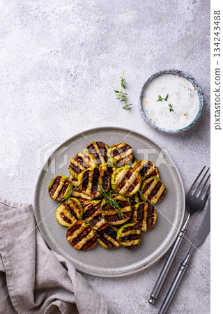 Grilled zucchini with garlic sauce 134243488