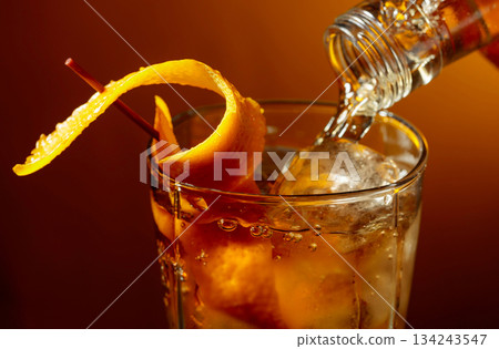 Old-fashioned cocktail classic bourbon whiskey and bitters, garnished with orange peel. Old-fashioned cocktail classic bourbon whiskey and bitters, garnished with orange peel. 134243547