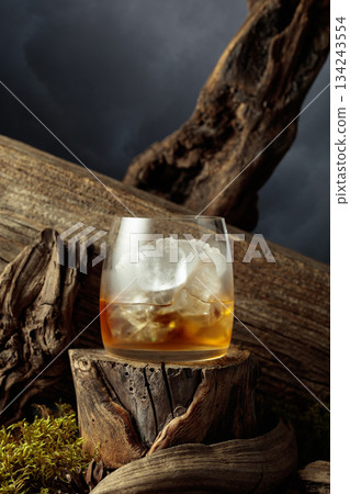 Whiskey on ice on an old wooden stump. Whiskey on ice on an old wooden stump. 134243554