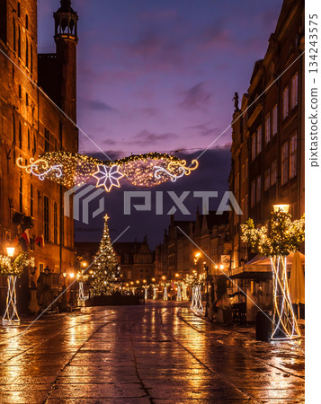 Enchanting Night Street With Christmas Lights, Decorated Trees, And Cozy Outdoor Cafes In Old Town, Gdansk, Poland 134243575