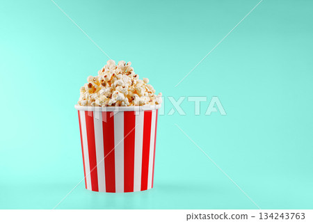 Classic red striped popcorn cardboard cup on blue background 134243763