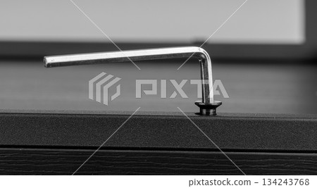 Allen Key Tightening Hex Screw in Metal Surface Close-Up Allen Key Tightening Hex Screw in Metal Surface Close-Up 134243768