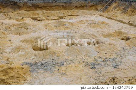 Construction site dug holes in sand in preparation for building work at rural location 134243799