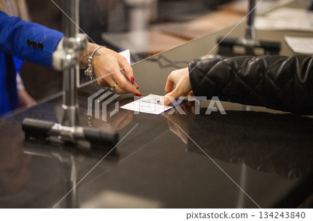Exchanging documents through a hotel reception Exchanging documents through a hotel reception 134243840