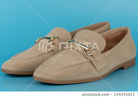 High-quality loafers placed on a blue background for display High-quality loafers placed on a blue background for display 134243853