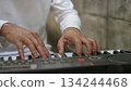 Hands On Keyboard Musicians Performance With White Keys, Business In Background 134244468