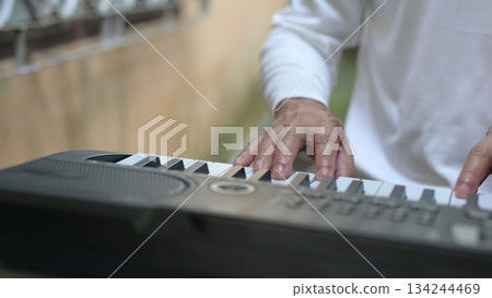 Black And White Keyboard Close Up Persons Hand Plays Electronic Synthesizer Keys, Soft Background 134244469
