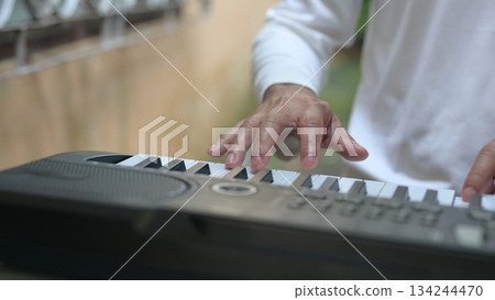 White Keyboard Keys Under Hand Composers Devotion To Music, Forming Trio Quartet On White Background 134244470