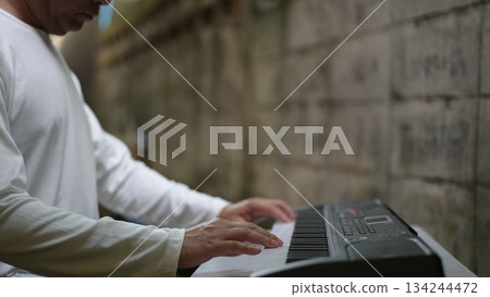 Peaceful Musicians Hand Dance White Shirt, Keyboard Keys, Light On Textured Wall Peaceful Musicians Hand Dance White Shirt, Keyboard Keys, Light On Textured Wall 134244472