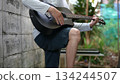Acoustic Guitar Serenade Outdoor Musicians Hand Mastering Six String Body, Against Weathered Wall Effect 134244507