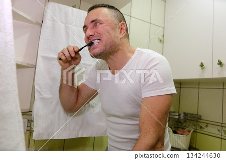 Morning routine of washing the teeth. Handsome young man is brushing teeth with toothbrush. Morning routine of washing the teeth. Handsome young man is brushing teeth with toothbrush. 134244630