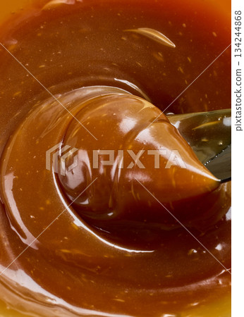 freshly cooked caramel sauce background 134244868
