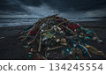 A mountain of fishing nets and marine plastic waste washed up on a stormy beach 134245554