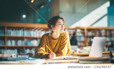 Adult woman studying in the library Adult woman studying in the library 134246547