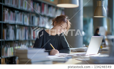 Adult woman studying in the library 134246549