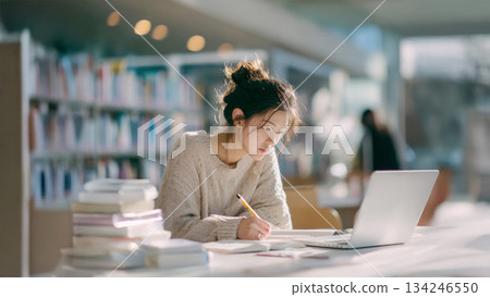 Adult woman studying in the library Adult woman studying in the library 134246550