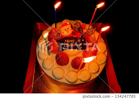 A whole cake with lit Christmas candles 134247785