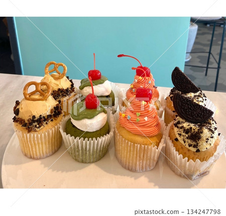 A delightful cupcake topped with rich frosting and decorative sprinkles. Perfect for dessert photography, showcasing the charm and sweetness of baked goods, ideal for parties and celebrations. 134247798