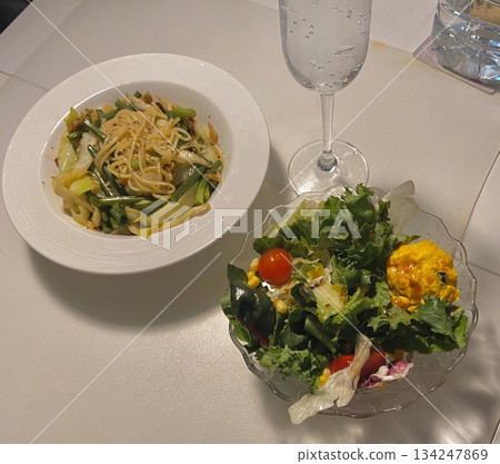 Spaghetti salad combines al dente pasta with fresh vegetables, tangy dressing, and optional herbs or cheese. A vibrant, refreshing dish perfect for light meals or gatherings. 134247869