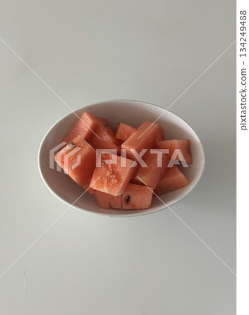 Fresh red watermelon cubes, juicy and refreshing, perfect for a sweet, hydrating snack or as a colorful addition to salads and fruit bowls. A summer favorite that offers natural sweetness. 134249488