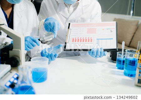 Scientist team with tablet and laptop, laboratory and ecofriendly science. Agriculture, research and scientists with online reading 134249602