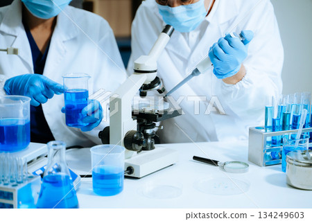 Scientist team with tablet and laptop, laboratory and ecofriendly science. Agriculture, research and scientists with online reading 134249603