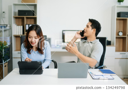 Male discussing new project with male colleague. Young woman talking with young man 134249798