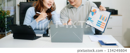 Two business workers talking on the smartphone and using laptop Two business workers talking on the smartphone and using laptop 134249804