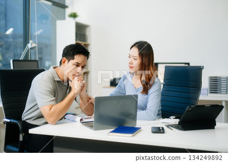Furious two Asian businesspeople arguing strongly after making a mistake at work 134249892