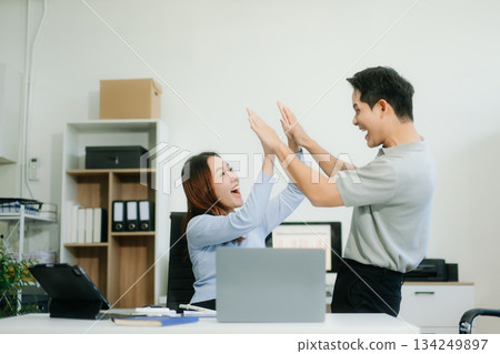 Asian business team creative businesspeople coworker, teamwork celebrating achievement and in planning design Asian business team creative businesspeople coworker, teamwork celebrating achievement and in planning design 134249897