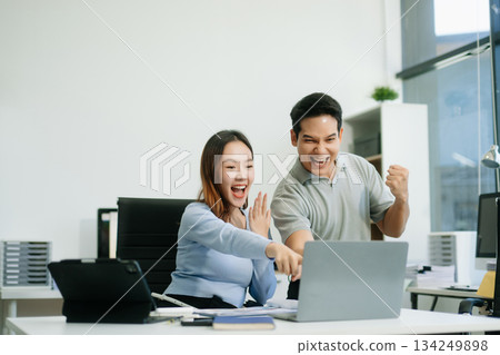Asian business team creative businesspeople coworker, teamwork celebrating achievement and in planning design 134249898
