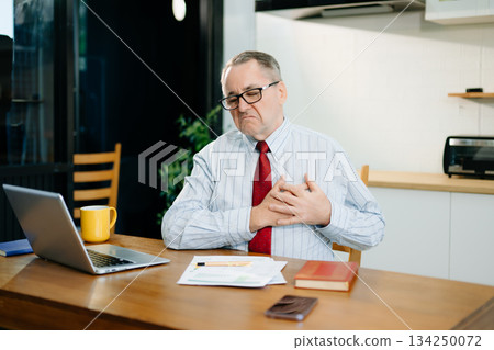 Overworked businessman office worker suffering from neck pain after had a long day at desk. office syndrome concept Overworked businessman office worker suffering from neck pain after had a long day at desk. office syndrome concept 134250072