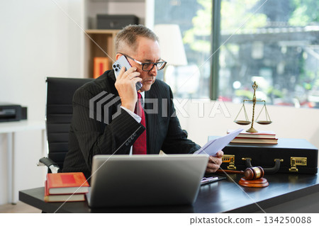Professional male lawyers consulting on legal cases in a modern office. Perfect for law, business, justice, legal advice, corporate attorneys 134250088