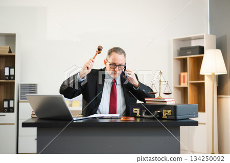 Professional male lawyers consulting on legal cases in a modern office. Perfect for law, business, justice, legal advice, corporate attorneys Professional male lawyers consulting on legal cases in a modern office. Perfect for law, business, justice, legal advice, corporate attorneys 134250092