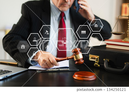 justice and law concept. Male judge in a courtroom the gavel, working with smart phone and laptop and digital tablet 134250121