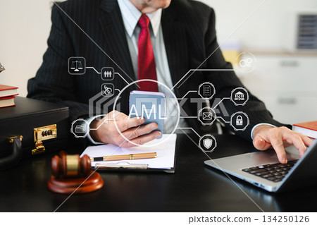AML Anti Money Laundering Financial Bank Business Concept. judge in a courtroom using laptop and tablet AML Anti Money Laundering Financial Bank Business Concept. judge in a courtroom using laptop and tablet 134250126