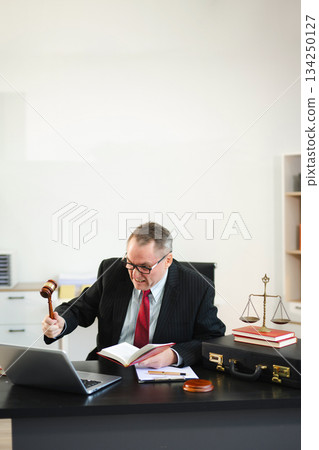 Man lawyer working and gavel, tablet, laptop in front, Advice justice and law concept. Man lawyer working and gavel, tablet, laptop in front, Advice justice and law concept. 134250127