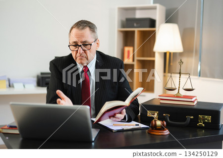 Caucasian male judge in courtroom, lawyer working in office. Perfect for business, legal advice, corporate law 134250129