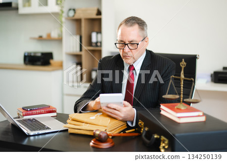 Male judge in courtroom, lawyer working in office. Perfect for business, legal advice, corporate law Male judge in courtroom, lawyer working in office. Perfect for business, legal advice, corporate law 134250139