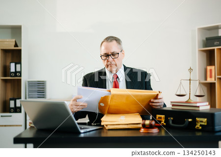 Professional male lawyers consulting on legal cases in a modern office. Perfect for law, business, justice, legal advice 134250143