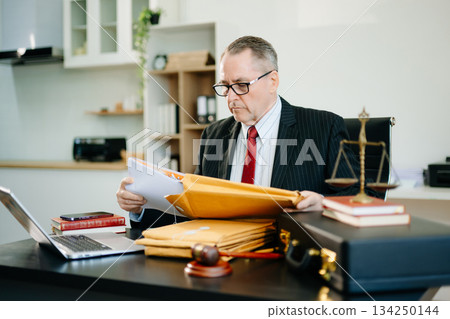 Male judge in courtroom, lawyer working in office. Perfect for business, legal advice, corporate law, and professional consulting themes. 134250144