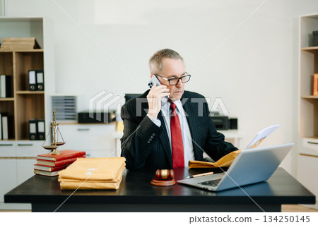 Male judge in courtroom, lawyer working in office. Perfect for business, legal advice, corporate law, and professional consulting themes. 134250145