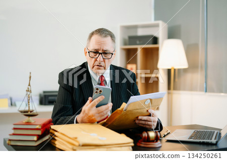 Professional male lawyers consulting on legal cases in a modern office. Perfect for law, business, justice, legal advice Professional male lawyers consulting on legal cases in a modern office. Perfect for law, business, justice, legal advice 134250261