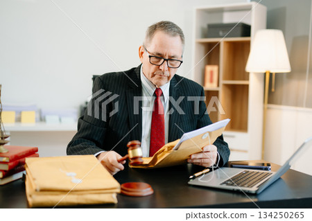 Male judge in courtroom, lawyer working in office. Perfect for business, legal advice, corporate law, and professional consulting themes. Male judge in courtroom, lawyer working in office. Perfect for business, legal advice, corporate law, and professional consulting themes. 134250265