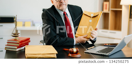 Justice and law concept.Male judge in a courtroom on white table and Counselor or Male lawyer working in office. 134250275
