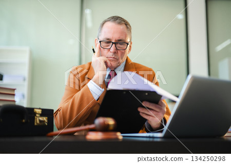 Caucasian male judge in courtroom, lawyer working in office. Perfect for business, legal advice, corporate law 134250298